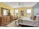 Bedroom with yellow walls, carpet, ceiling fan, two windows and furniture at 6241 Colonial Dr, Whitestown, IN 46075