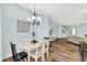Bright dining room featuring wood-look floors and a modern chandelier at 6241 Colonial Dr, Whitestown, IN 46075