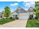 Beautiful exterior featuring manicured lawn, an attached garage, and traditional architectural elements at 6241 Colonial Dr, Whitestown, IN 46075