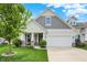 Charming home featuring a well-maintained lawn, attached two-car garage and inviting front porch at 6241 Colonial Dr, Whitestown, IN 46075