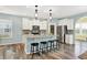 Well-lit kitchen featuring a central island with seating, stainless steel appliances, and ample cabinet space at 6241 Colonial Dr, Whitestown, IN 46075