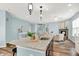 Open-concept kitchen with granite counters, an island, and an eat-in breakfast bar, perfect for modern living at 6241 Colonial Dr, Whitestown, IN 46075