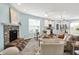 Open-concept living room flowing into the kitchen, with a stone fireplace and comfortable furnishings at 6241 Colonial Dr, Whitestown, IN 46075