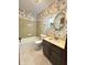 Vintage bathroom featuring floral wallpaper, a bathtub, and sink vanity, providing functionality and comfort at 645 Boulder Rd, Indianapolis, IN 46217