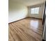 Bright bedroom with wood-look floors and a large window for natural light at 645 Boulder Rd, Indianapolis, IN 46217