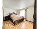 Serene bedroom features wood laminate flooring, a large window, and an elegant bed frame at 645 Boulder Rd, Indianapolis, IN 46217