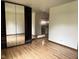 Bright bedroom with wood-look flooring and a mirrored wardrobe, offering a clean and modern feel at 645 Boulder Rd, Indianapolis, IN 46217