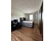Inviting bedroom featuring wood laminate flooring, a large window, and a closet at 645 Boulder Rd, Indianapolis, IN 46217