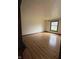 Bright bedroom with hardwood floors and a window overlooking the front yard at 645 Boulder Rd, Indianapolis, IN 46217