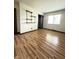 Spacious bedroom with light-filled window and wood-look floors, complemented by closet and shelving at 645 Boulder Rd, Indianapolis, IN 46217