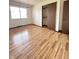 Bedroom with wood-look floors, closet and a window allowing ample natural light at 645 Boulder Rd, Indianapolis, IN 46217