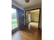 Inviting entryway leading to a dining room with hardwood floors and vintage-style wallpaper at 645 Boulder Rd, Indianapolis, IN 46217