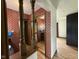 Hallway view featuring bathroom entry and hardwood floors, providing visual access to other rooms at 645 Boulder Rd, Indianapolis, IN 46217