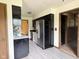 Kitchen with black cabinets and stainless steel refrigerator at 645 Boulder Rd, Indianapolis, IN 46217
