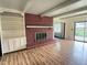 Bright living room featuring a red-brick fireplace with white accents and built-in shelving at 645 Boulder Rd, Indianapolis, IN 46217