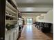 Spacious living room with a brick fireplace, built-in shelving, and wood laminate flooring at 645 Boulder Rd, Indianapolis, IN 46217
