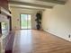 Large living room with wood-look floors, a red-brick fireplace, and sliding glass doors at 645 Boulder Rd, Indianapolis, IN 46217