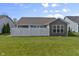 This backyard features a well-maintained lawn and privacy fence, perfect for outdoor entertaining and relaxation at 6738 Fox Club Ln, Brownsburg, IN 46112