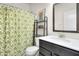 Bathroom with patterned shower curtain, a toilet and a vanity sink with storage below at 6738 Fox Club Ln, Brownsburg, IN 46112