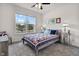 Comfortable bedroom with large window letting in natural light and a decorative bedspread at 6738 Fox Club Ln, Brownsburg, IN 46112