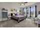 Cozy bedroom with a patterned quilt, ceiling fan, and three windows with decorative curtains at 6738 Fox Club Ln, Brownsburg, IN 46112