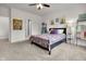 Cozy bedroom with a patterned quilt, ceiling fan, and artwork hanging on the walls at 6738 Fox Club Ln, Brownsburg, IN 46112