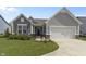 Charming home with a manicured lawn, gray siding, and a two-car garage at 6738 Fox Club Ln, Brownsburg, IN 46112