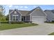 Well-maintained home with gray siding, a manicured lawn, and an attached two-car garage at 6738 Fox Club Ln, Brownsburg, IN 46112