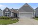 Charming home with a manicured lawn, gray siding, and a two-car garage at 6738 Fox Club Ln, Brownsburg, IN 46112