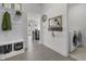 Foyer featuring a coat rack, bench, entryway mirror, and access to the laundry room at 6738 Fox Club Ln, Brownsburg, IN 46112