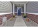 Inviting front porch with decorative wreath, potted plants, and stylish decor at 6738 Fox Club Ln, Brownsburg, IN 46112