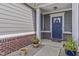 Inviting front porch with decorative wreath, potted plants, and stylish decor at 6738 Fox Club Ln, Brownsburg, IN 46112