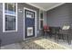 Cozy front porch features a seating area, stylish rug, and a blue door with sidelight windows at 6738 Fox Club Ln, Brownsburg, IN 46112