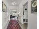 Bright hallway with coat rack and decor leads to a living space with comfortable seating and natural light at 6738 Fox Club Ln, Brownsburg, IN 46112