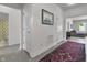 Hallway leading to a bathroom and living area, featuring stylish decor and ample natural light at 6738 Fox Club Ln, Brownsburg, IN 46112