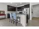 Stylish kitchen island with blue accent chairs, dark cabinets, and modern stainless steel appliances at 6738 Fox Club Ln, Brownsburg, IN 46112