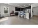 Open-concept kitchen with dark cabinetry, stainless steel appliances, and stylish seating at the island at 6738 Fox Club Ln, Brownsburg, IN 46112