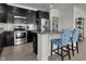 Kitchen features stainless steel appliances, dark cabinets, and breakfast bar with stylish stools at 6738 Fox Club Ln, Brownsburg, IN 46112