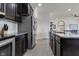 Modern kitchen with stainless steel appliances, white backsplash, and gray granite countertops at 6738 Fox Club Ln, Brownsburg, IN 46112