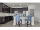 Kitchen features stainless steel appliances, dark cabinets, and breakfast bar with stylish stools at 6738 Fox Club Ln, Brownsburg, IN 46112