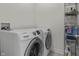 Laundry room featuring a matching washer and dryer set with wire storage shelving at 6738 Fox Club Ln, Brownsburg, IN 46112