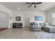 Open living room featuring a cozy gray sofa, bright art, and ample natural light at 6738 Fox Club Ln, Brownsburg, IN 46112