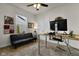 Functional home office with a sofa, desk, and natural light from the window at 6738 Fox Club Ln, Brownsburg, IN 46112