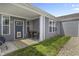 Back patio features a seating area, stylish rug, and a blue door with sidelight windows leading to the backyard at 6738 Fox Club Ln, Brownsburg, IN 46112