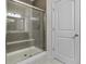 Modern shower with gray tile, glass door, and built in shelving at 6738 Fox Club Ln, Brownsburg, IN 46112