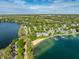 Stunning aerial shot showcasing a serene lakefront community with a private beach and boat docks at 7849 Clearwater Cove Dr, Indianapolis, IN 46240