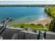 Beautiful aerial view of lakefront property, sandy beach, boat dock, and well-manicured grounds at 7849 Clearwater Cove Dr, Indianapolis, IN 46240