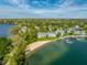 Gray townhouses, sandy beach, and docks blend into a picturesque, tranquil lakeside setting at 7849 Clearwater Cove Dr, Indianapolis, IN 46240
