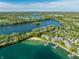 Aerial view of a lakefront community with a private beach and boat docks. Beautiful landscaping at 7849 Clearwater Cove Dr, Indianapolis, IN 46240