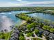 Aerial of community with lake access, featuring a sandy beach, private boat docks and mature trees at 7849 Clearwater Cove Dr, Indianapolis, IN 46240